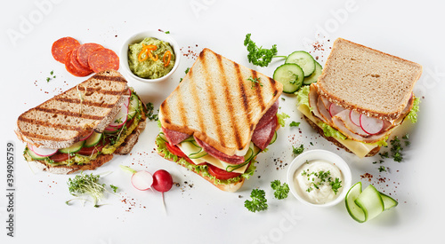 Trio of gourmet sandwiches on assorted bread