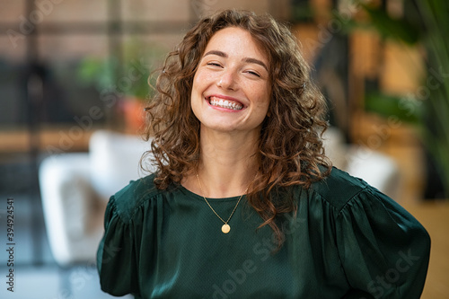 Satisfied business woman laughing at office