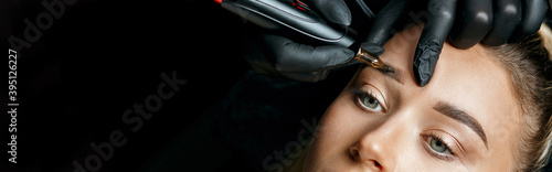 Tattoo artist doing permanent makeup