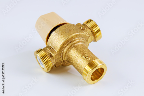 Water various supply plumbing brass thermostatic mixing valve isolated on white background.