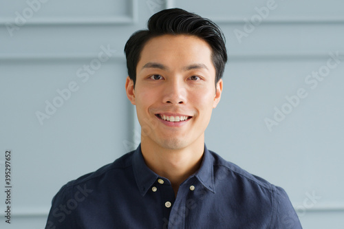 Portrait young confident smart Asian businessman look at camera and smile
