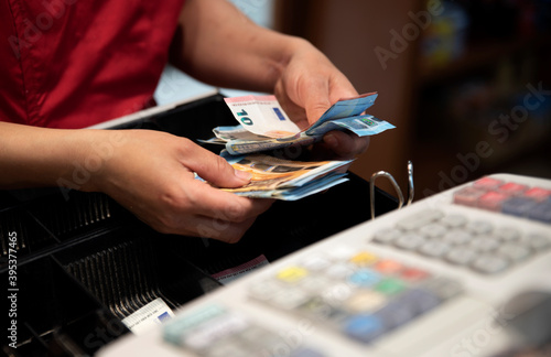 cashier counting the benefits of the day