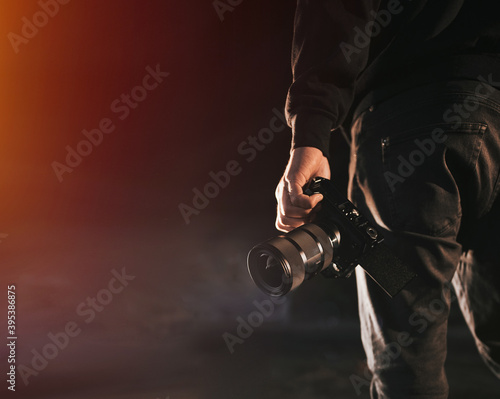 man holds camera. silhouette of videomaker