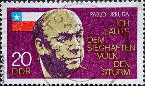 GERMANY, DDR - CIRCA 1974 : a postage stamp from Germany, GDR showing a portrait of the Chilean poet Pablo Neruda (1904–1973), with the Chilean flag