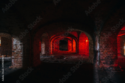 Dark and creepy vaulted red brick dungeon