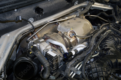 The turbocharger is installed on the engine of a modern powerful car.