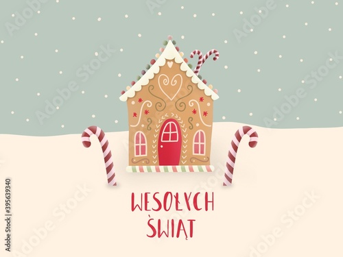 Domek z piernika i świąteczne laski cukrowe z czerwonym tekstem Wesołych Świąt, w tle jest śnieg i płatki śniegu