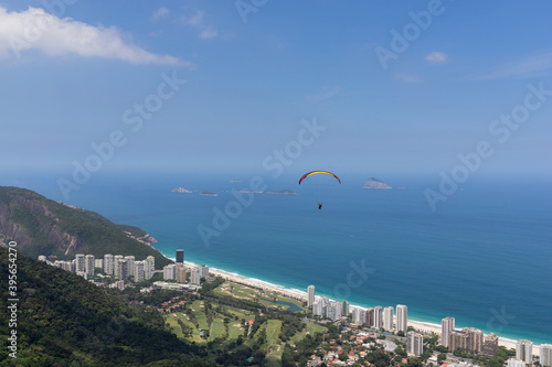 View of the beach with paraglider flying over