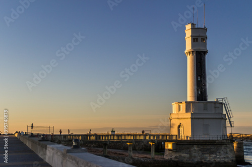 Harbor on the Basque coast and the lighthouse at sunset