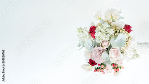 Horizontal banner with a beautiful delicate wedding bouquet made of artificial flowers. Copy or spare bouquet for the bride. Elegant bouquet in pastel shades with copy space for banners, invitations.