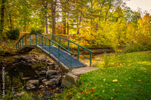 Autumn Fall Color Landscape. Small footbridge over a creek surrounded by vibrant fall foliage at a small county park in Jackson County, Michigan.