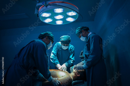 Surgical team or doctor and staff have vivisection in surgery room of the hospital and using equipment tool for the operation