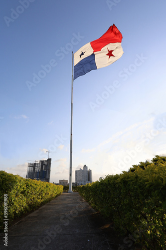 Vertical shot of the National flag of Panama with the skyline of Panama City in the background
