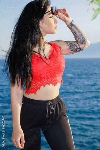 Attractive young brunette dressed in a red top