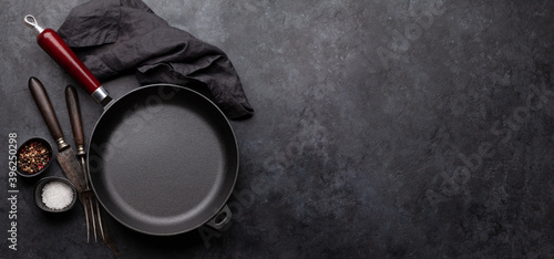 Frying pan, utensils and ingredients on kitchen table