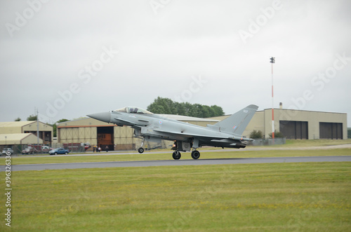 fighter jet landing on military airfield 