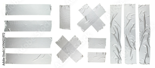 Set of different size silver grey adhesive tape on white background. Torn and crumpled pieces of grey sticky duct tape.