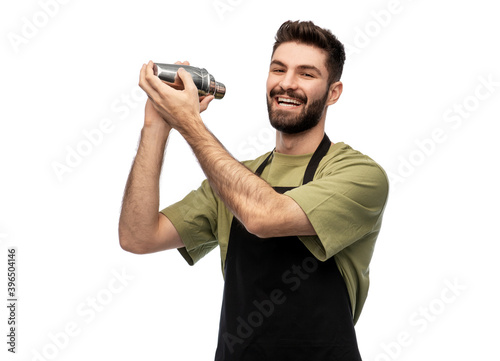 alcohol drinks, people and job concept - happy smiling barman with shaker preparing cocktail over white background