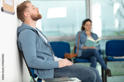 man sitting in doctors waiting room