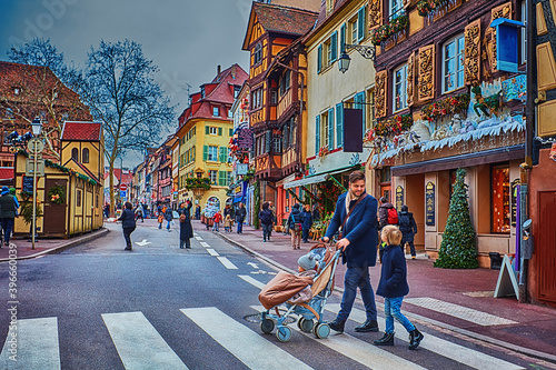 happy people crossing the street of Colmar town during Christmas holidays. Alsace, France