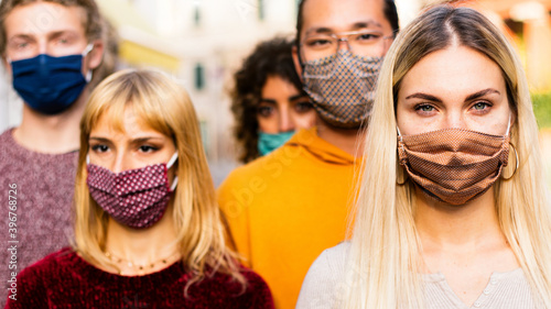 New normal lifestyle concept with multiracial people covered by face mask walking on city street 