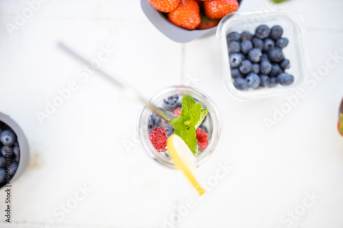 Berries and lemon drink in a jar from above