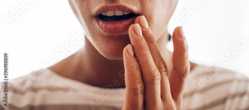 Young woman suffering from herpes on lips. Treatment of herpes infection and virus 