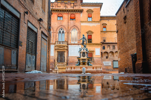 Neptune fountain Bologna, Italy - medieval bricks town with archs. Sunrise moment 