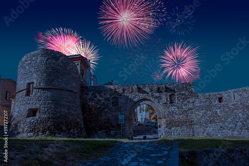 Celebratory fireworks for new year over Melfi's castle, a medieval stone bricks castle in south of italy in Basilicata during last night of year. Christmas atmosphere