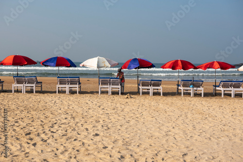 Goa, India- 11 November 2020, Early Morning beach with sun beds and colorful umbrellas on the baga beach in Goa India