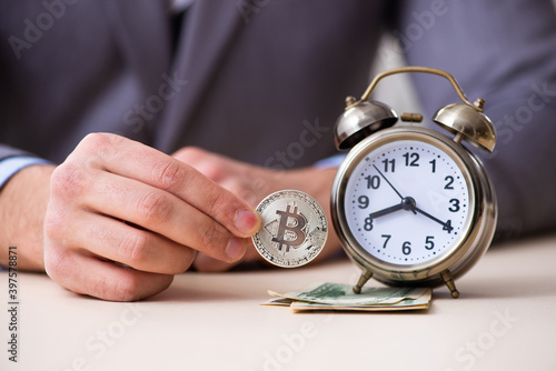Young man earning money via Internet in time management concept