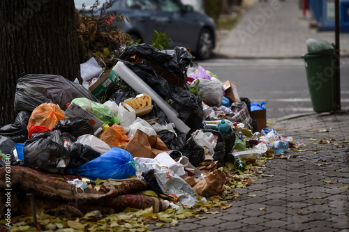 Piles of household waste are abandoned on the streets of Bucharest