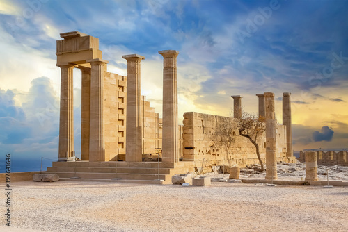 Ancient Greek acropolis. Front view of columns and walls. near the tree grows.