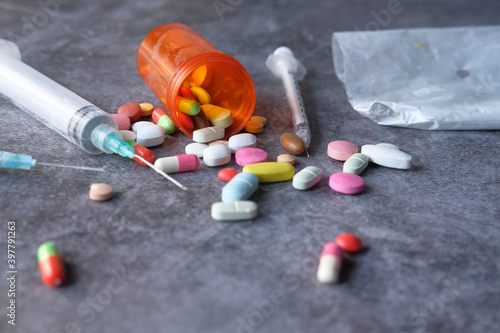 syringe , pills and capsules on table 