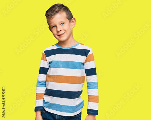 Adorable caucasian kid wearing casual clothes looking positive and happy standing and smiling with a confident smile showing teeth