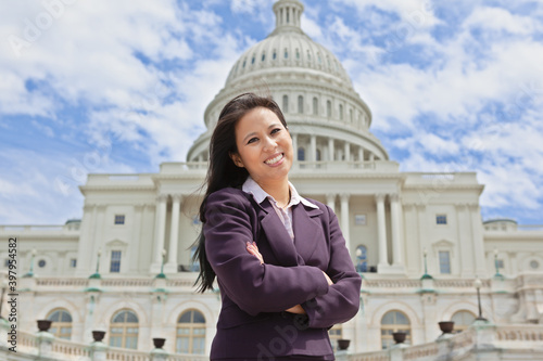 Beautiful mid adult Asian American woman in front of the U.S. Capitol building in Washington, DC