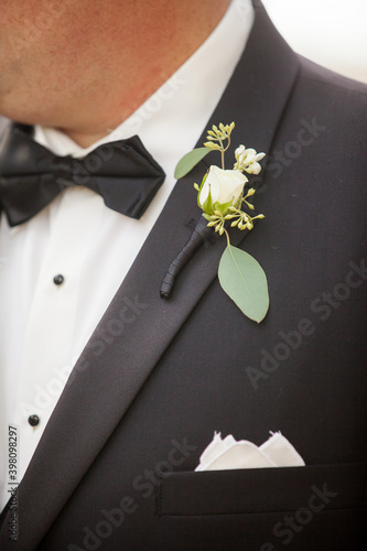 black tuxedo and bow tie with boutonniere