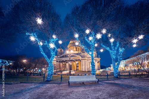 Christmas lights in Saint Petersburg. New year in Russia. St. Isaac's Cathedral on a winter night. Trees decorated with garlands. Christmas excursions in Saint Petersburg. Winter tour to Russia