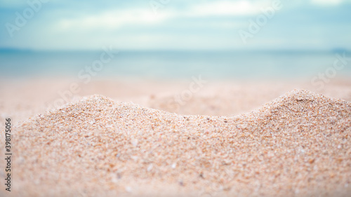 Sand desert pile with blur blue sea and blue sky on coast for contains articles about the sea or travel summer in holiday or environmental protection.