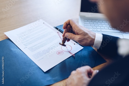 Notary public stamping and notarize document in his office