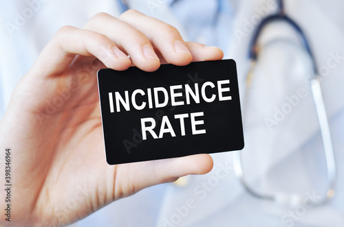 doctor holding a paper card with text incidence rate, medical concept