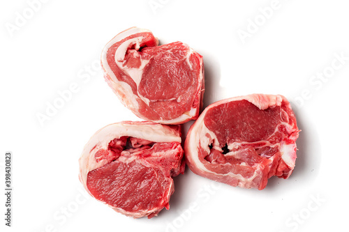 Three raw uncooked lamb loin chops on a white background, isolated, Meat industry product