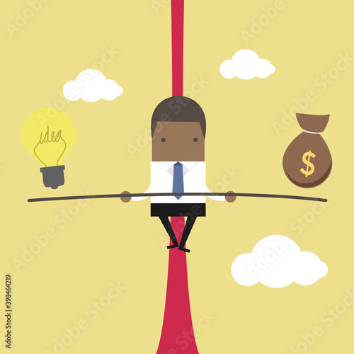 African businessman balancing on the rope with ideas and money.