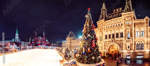 Moscow, Russia New Year. Christmas tree, shining lights of GUM shopping mall on Red Square. Holidays snowy winter night landscape. Festively decorated Red Square in snow. Christmas Market fairytale 