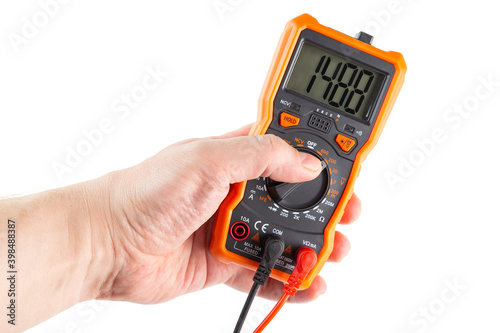 digit 1488 on lcd screen of digital electrical multimeter in left hand, isolated on white background