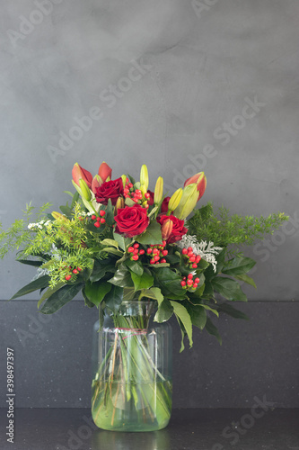 Bouquet of red flowers on a gray background texture