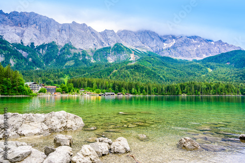Eibsee lake with Zugspitze mountain in the background. Beautiful landscape scenery with paradise beach and clear blue water in German Alps - Garmisch Partenkirchen, Grainau - Bavaria, Germany, Europe.