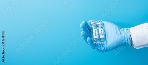 COVID-19 Vaccine vial against Coronavirus infection in hand of doctor with Nitrile Glove in hospital laboratory. Medical, health, Vaccination and immunization concept