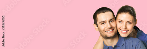 Love, relationship, lovers concept - studio portrait image of happy smiling embracing couple, man and woman in piggyback pose, isolate over pink color background. Copy space for text.