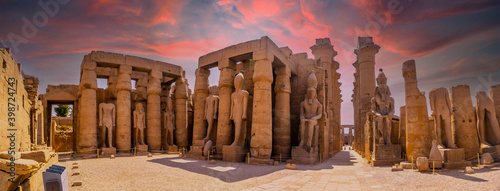 Sculptures of ancient Egyptian pharaohs and drawings on the columns of the Luxor Temple in the evening. Egypt